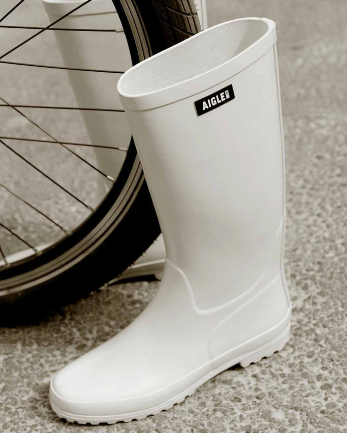 Sable coloured Aigle Womens Eliosa Wellingtons on street background #colour_sable