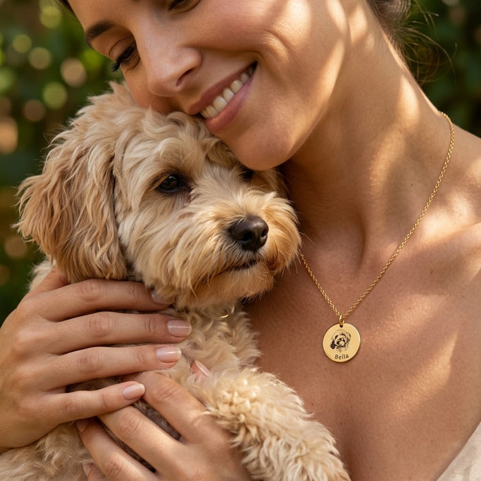 Personalized pet portrait necklace worn by a woman holding her dog, showing a meaningful dog mom keepsake gift.