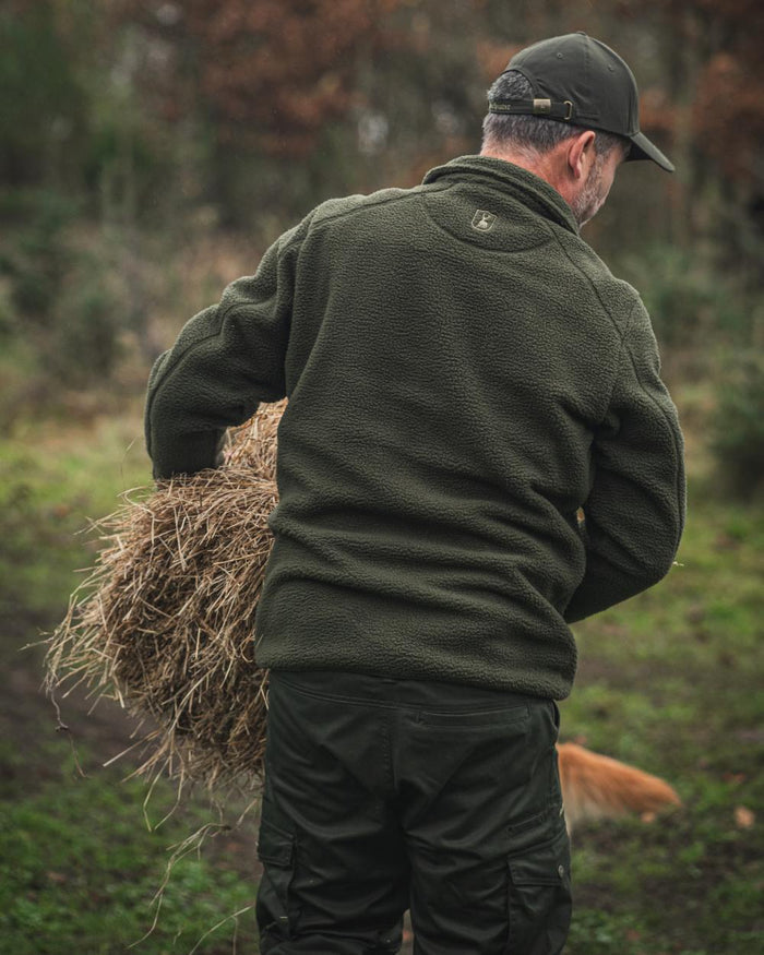 Forest Green coloured Deerhunter Atlas Fleece Jacket on forest background #colour_forest-green