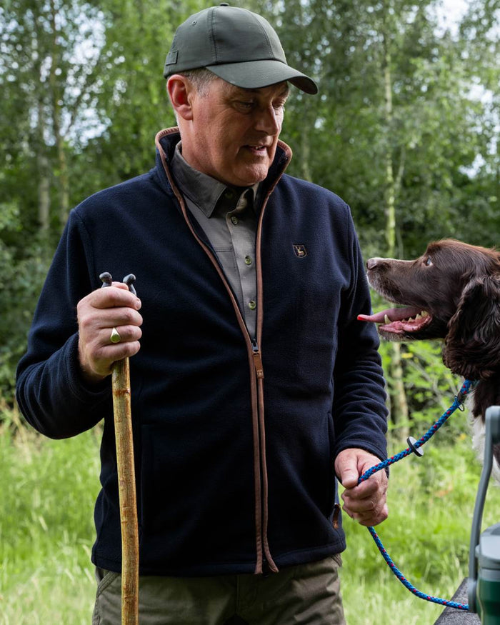 Dark Blue coloured Deerhunter Cumbria Fleece Jacket on forest background #colour_dark-blue