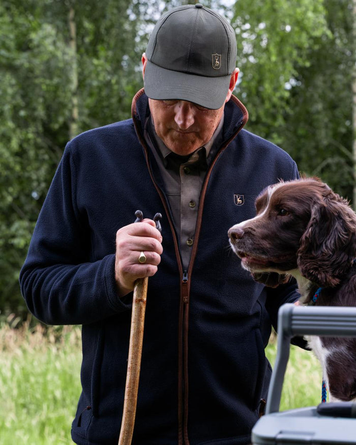 Dark Blue coloured Deerhunter Cumbria Fleece Jacket on forest background #colour_dark-blue