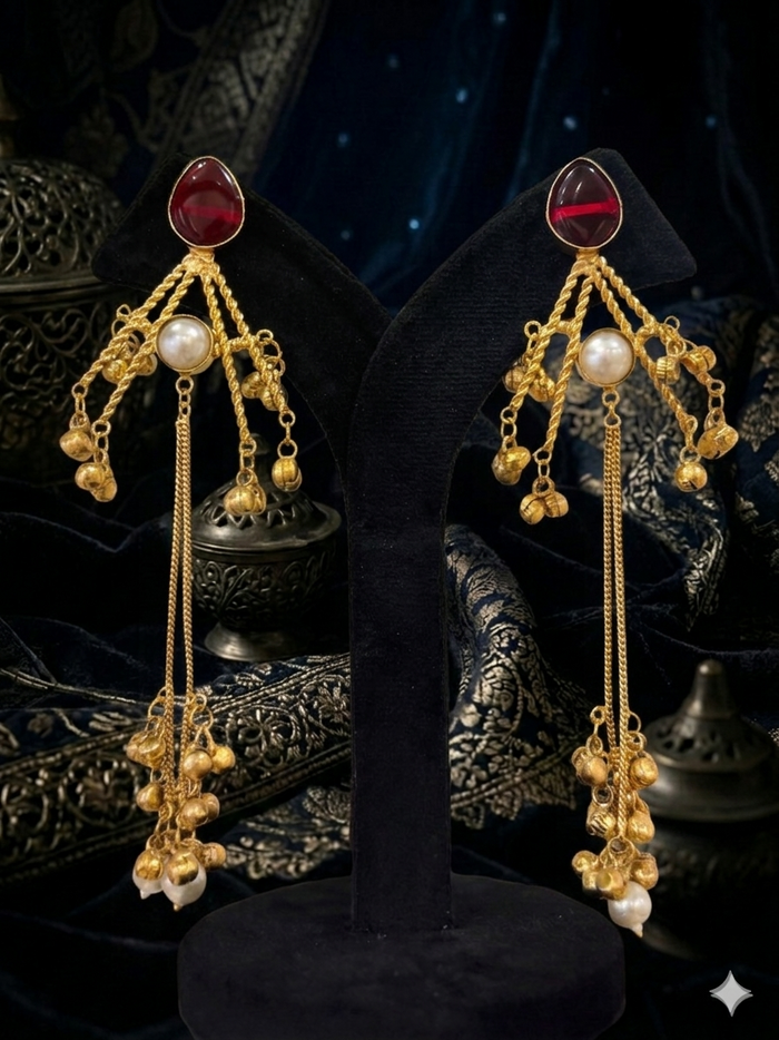 Gold earrings with red gemstones