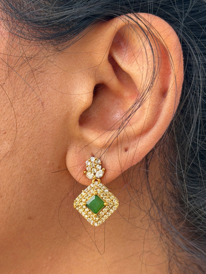 gold earring with green stone