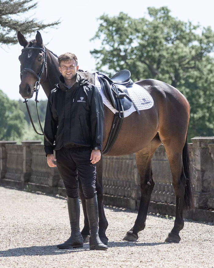 Black coloured Equidry Mens Equimac Shortie With Stowaway Hood on outdoor background #colour_black