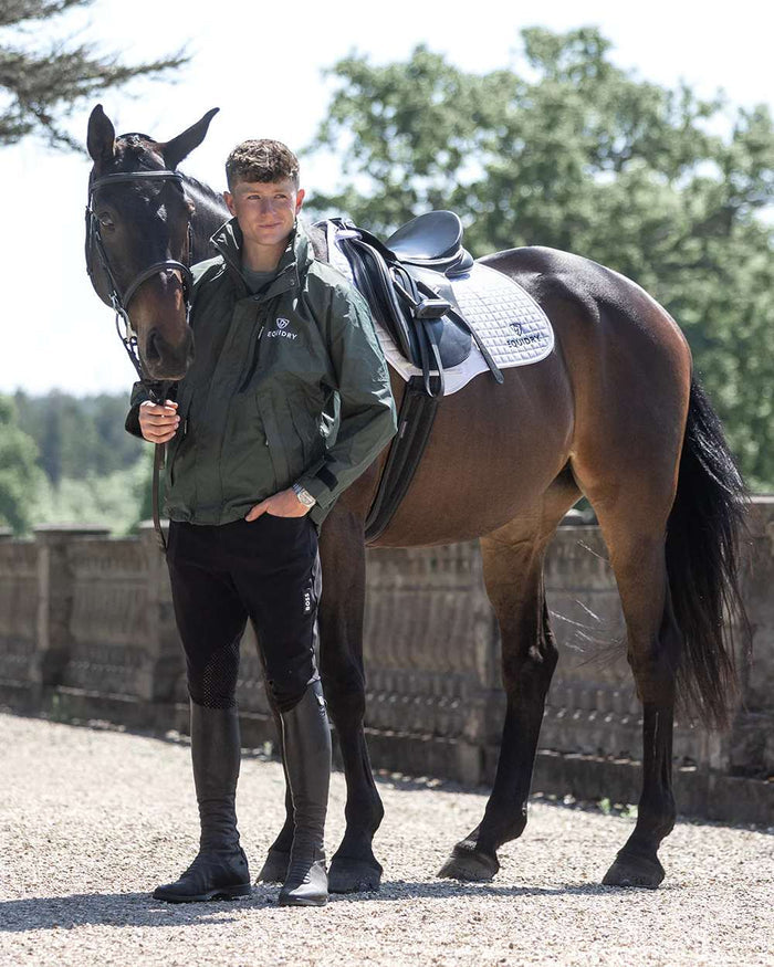 Black Forest Green coloured Equidry Mens Equimac Shortie With Stowaway Hood on street background #colour_black-forest-green