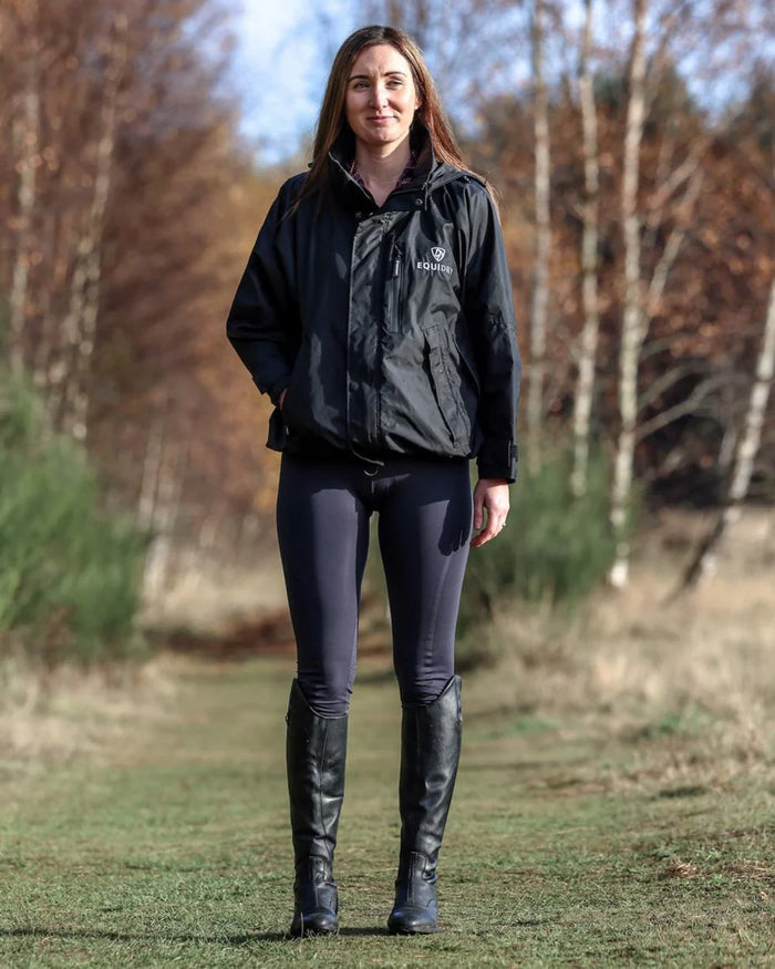 Black coloured Equidry Womens Equimac Shortie With Stowaway Hood on outdoor background #colour_black