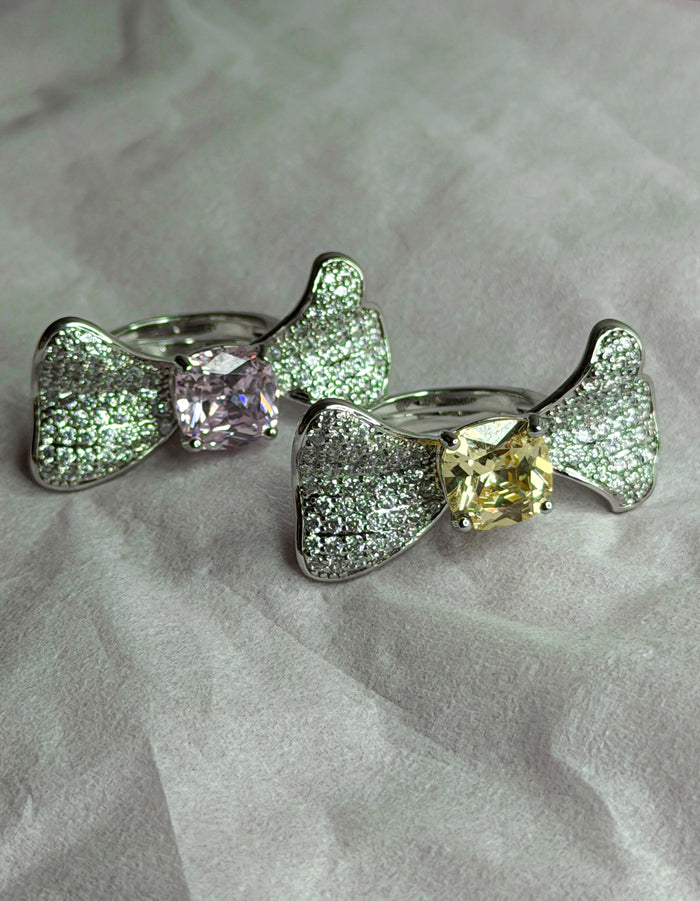 Two silver bow-shaped rings