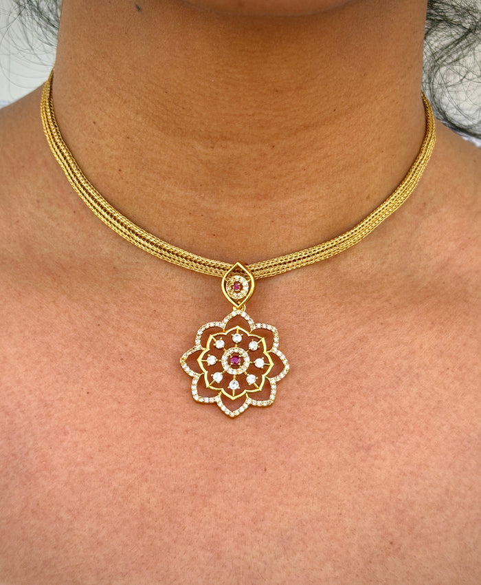 gold neklace with pink stone