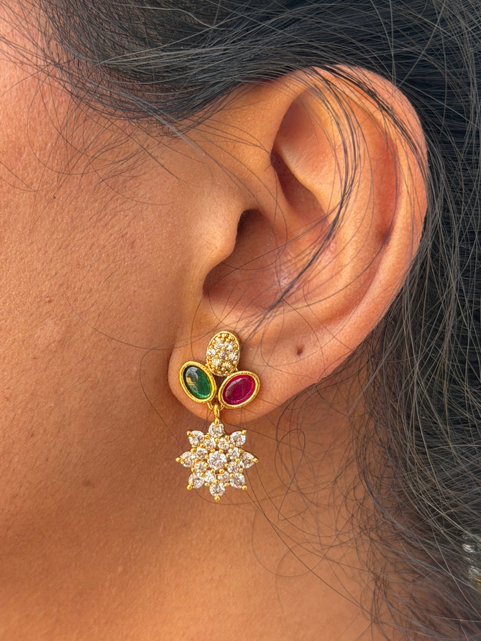 ear wearing a gold earring
