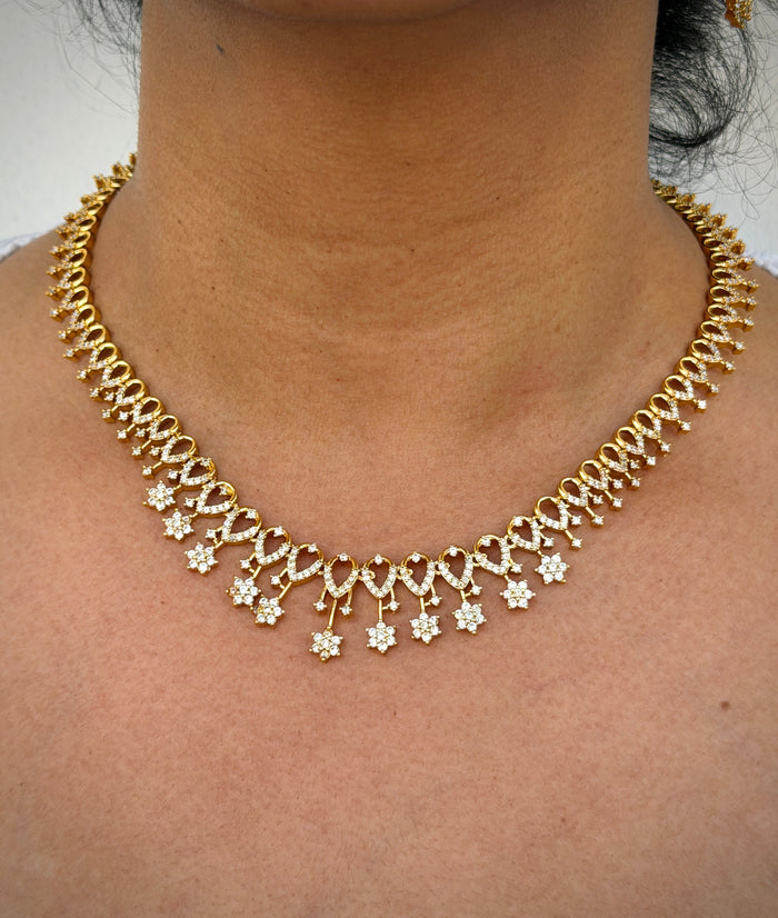 gold neklace with white stone