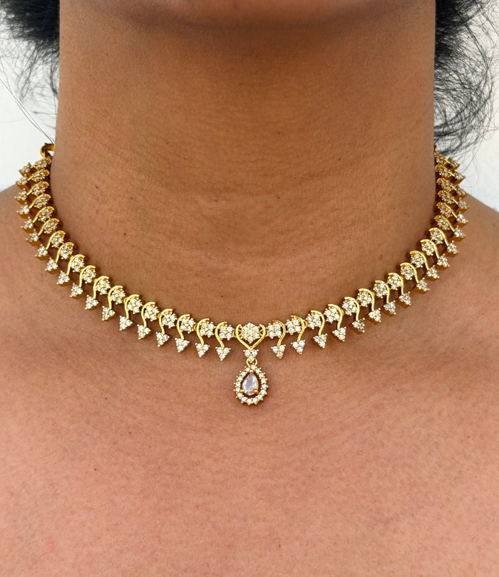Gold necklace with white stone
