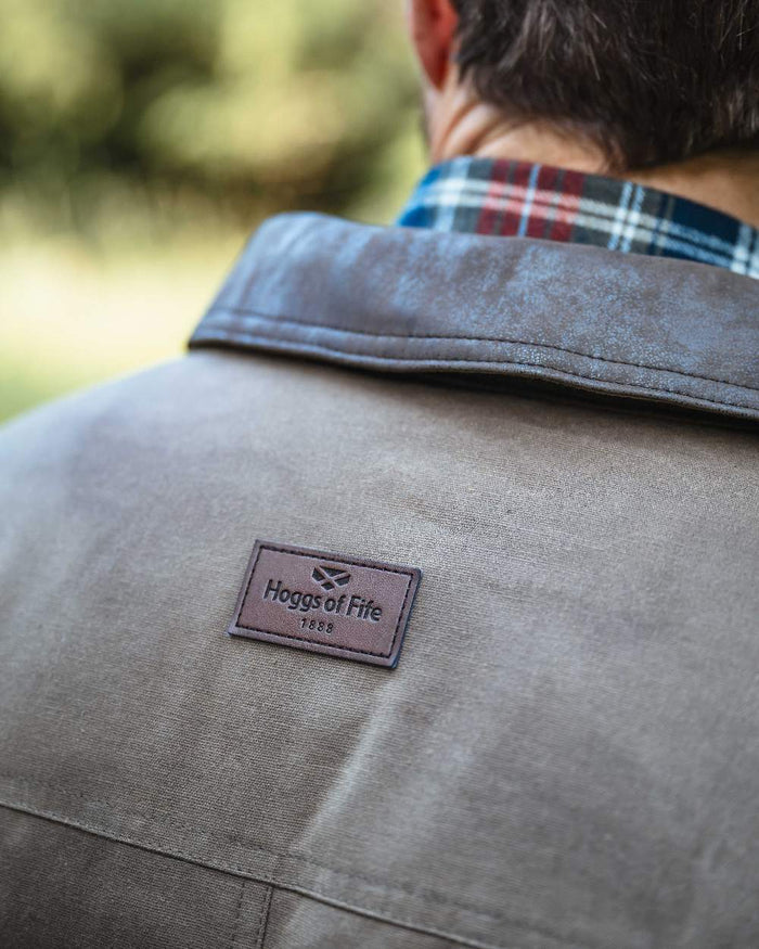 Rock Coloured Hoggs of Fife Balerno Waxed Canvas Barn Coat on outdoor background #colour_rock