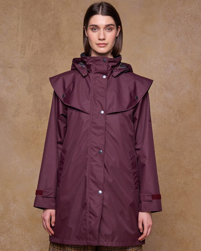 Deep Claret Coloured Jack Murphy Womens Dingle Waterproof Jacket on indoor background #colour_deep-claret