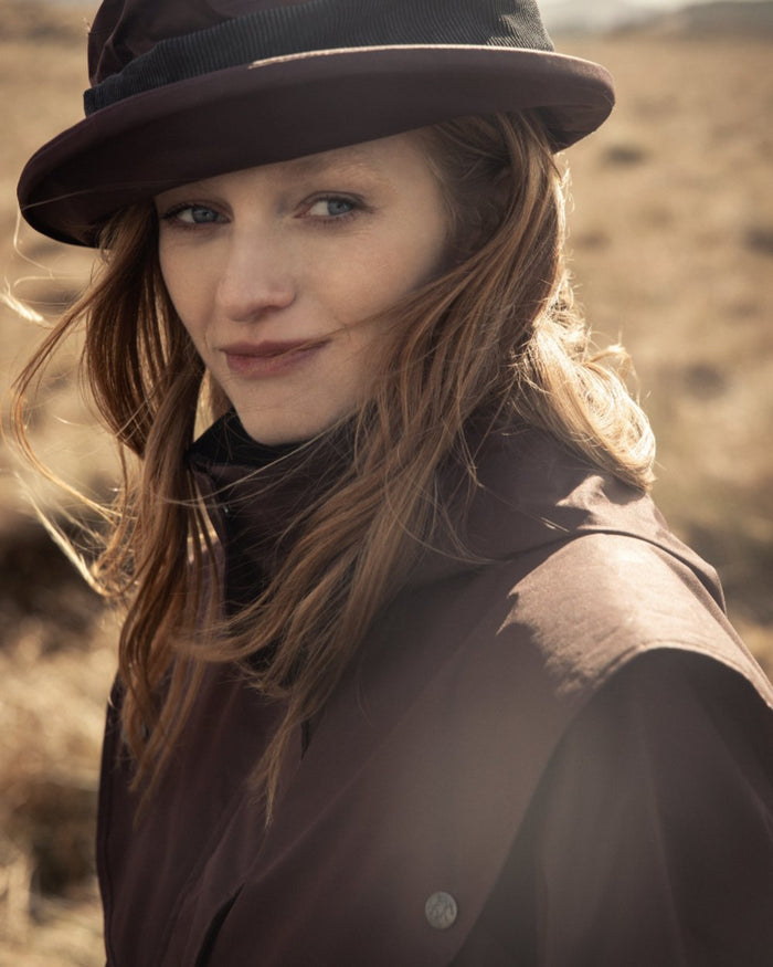 Deep Claret Coloured Jack Murphy Womens Dingle Waterproof Jacket on mountain background #colour_deep-claret