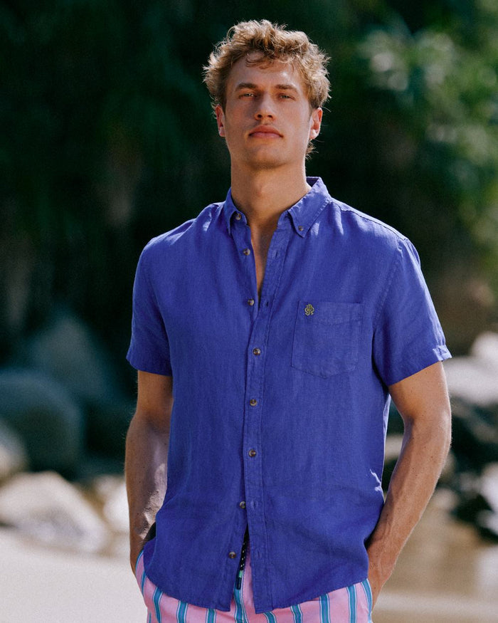 Blue coloured Joules Mens Pure Linen Short Sleeve Classic Fit Shirt on outdoor background #colour_blue