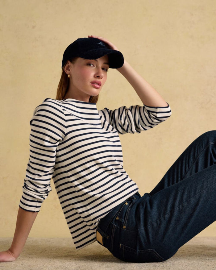 Cream Navy coloured Joules Womens Harbour Long Sleeve Striped Boat Neck Breton Top on wall background #colour_cream-navy