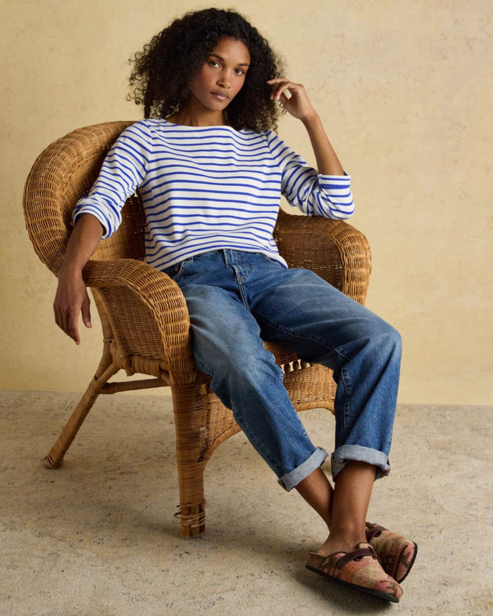 Blue Stripe coloured Joules Womens Harbour Long Sleeve Striped Boat Neck Breton Top on wall background #colour_blue-stripe