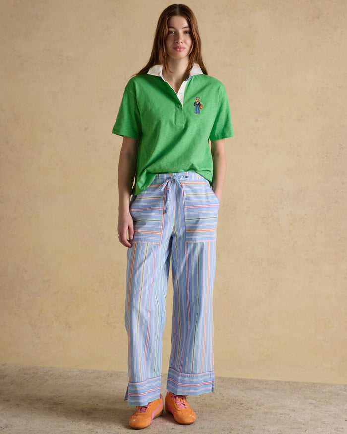 Green coloured Joules Womens Jonty Short Sleeve Cotton Rugby Shirt on wall background #colour_green