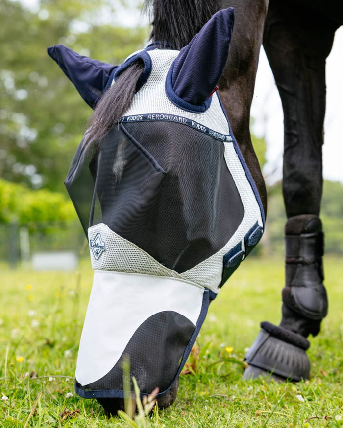 Navy coloured LeMieux Kudos AeroGuard Full Fly Mask on grass background #colour_navy