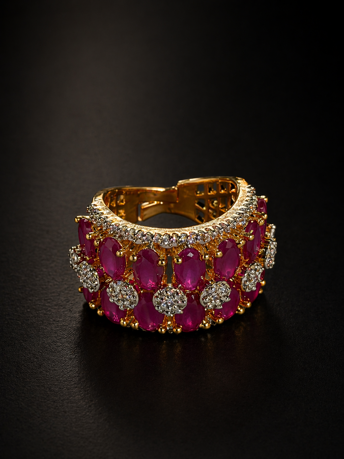 Gold bracelet with red gemstones