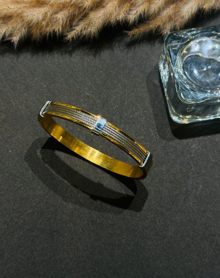 Gold bracelet with blue gemstone