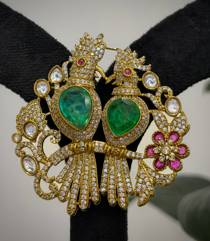 Ornate gold earrings with green gemstones