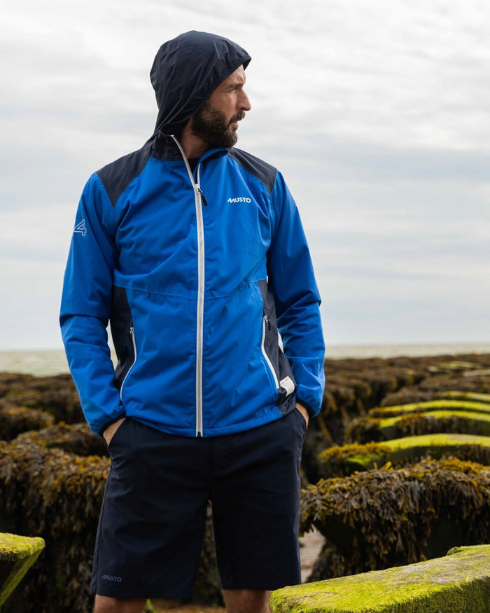 Navy Coloured Musto Mens RIB Fast Dry Shorts On A Coastal Background #colour_navy