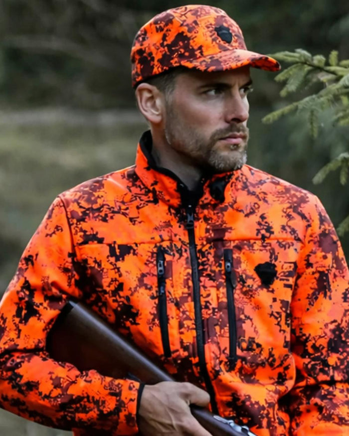 Camo Orange Blaze coloured Northern Hunting Asle Camo Cap on forest background #colour_camo-orange-blaze