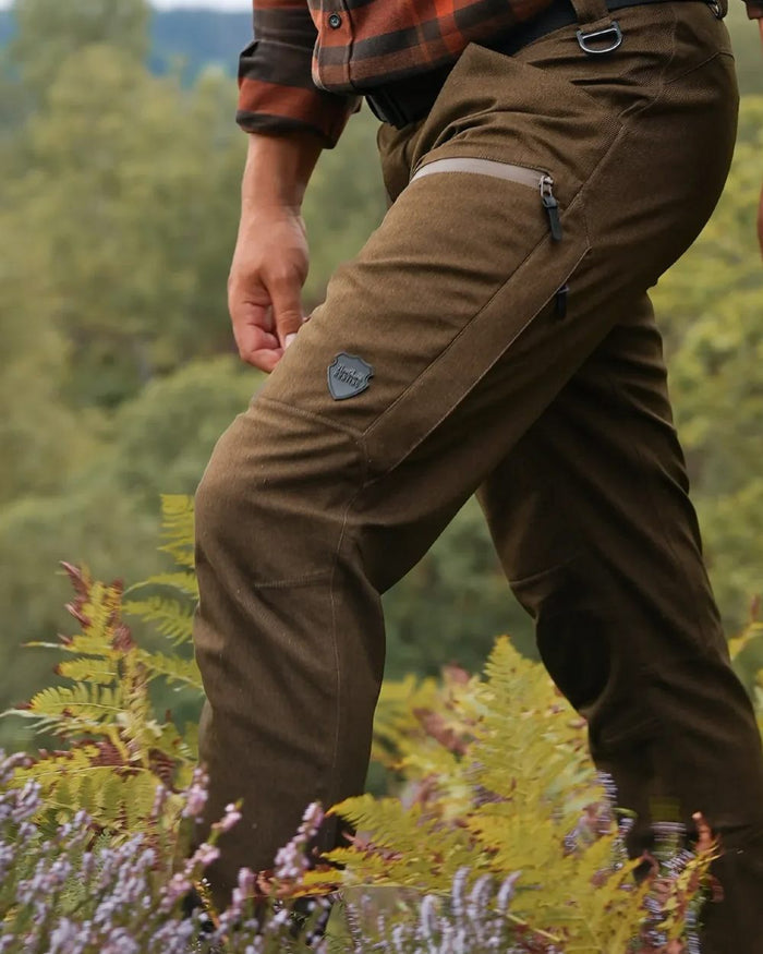 Green coloured Northern Hunting Mens Gunnar Alp Waterproof Addventex Hunting Trousers on forest background #colour_green