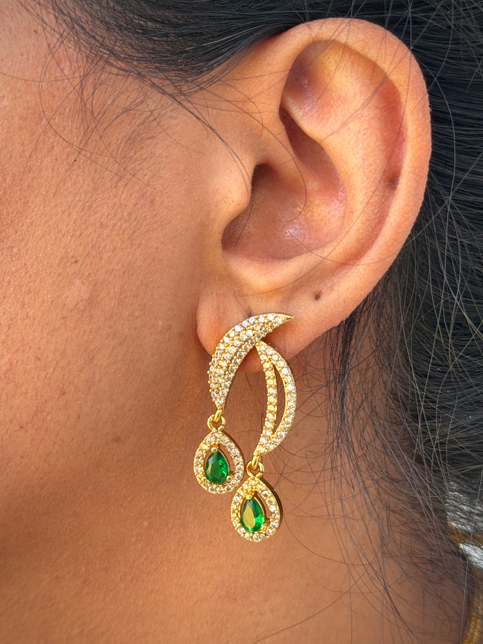 Gold earrings with green gemstones