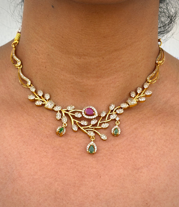 Gold necklace with gemstones on a person's neck