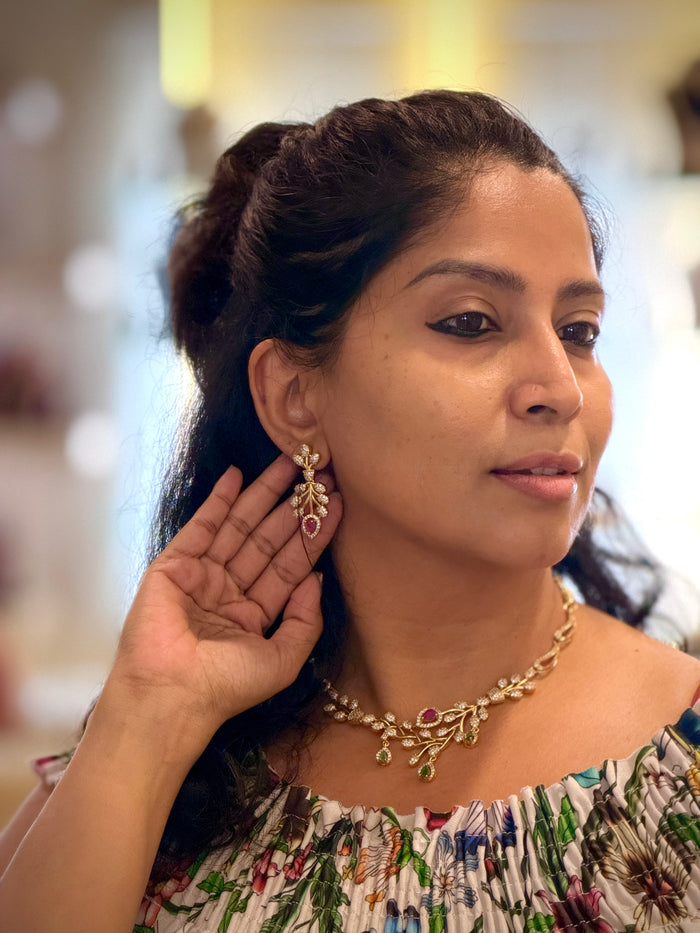 Woman wearing gold earrings and a necklace