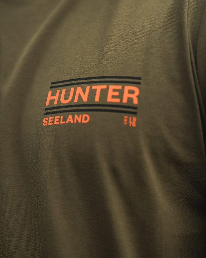 Military Olive Coloured Seeland On Point T-Shirt on outdoor background #colour_military-olive