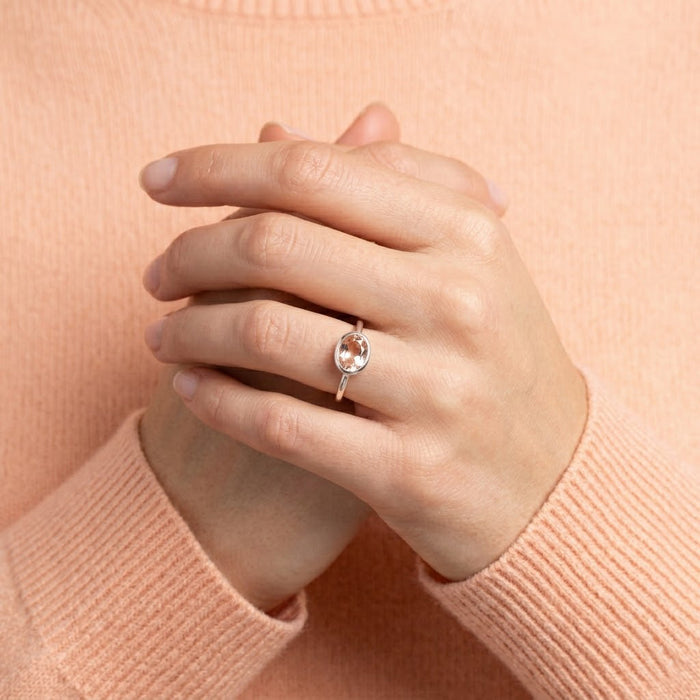 Morganite ring on model hand, dainty oval bezel set pink gemstone ring in gold