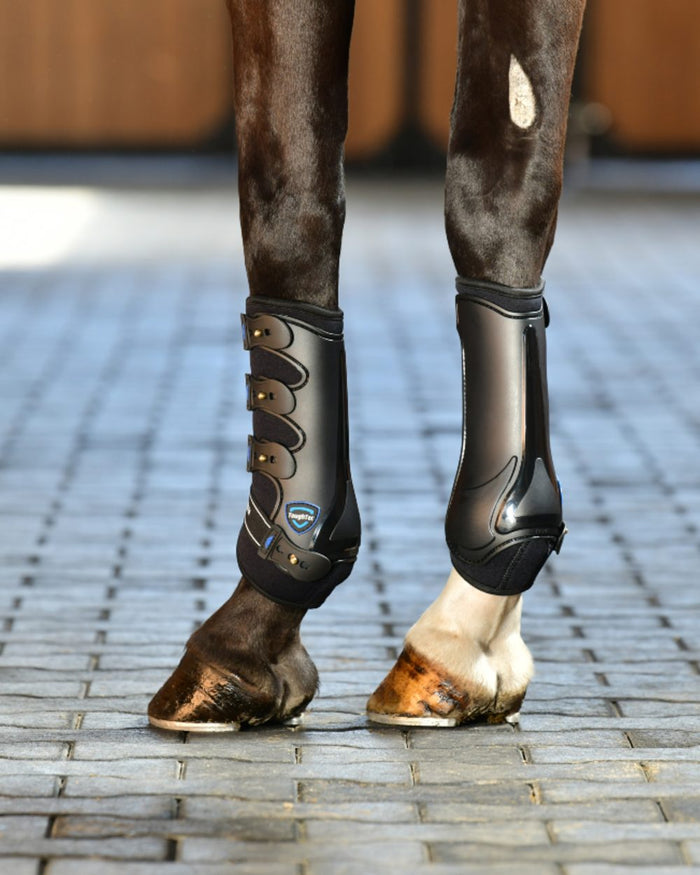 Black Coloured WeatherBeeta Tough-Tec Hard Shell Dressage Boots on horse background #colour_black