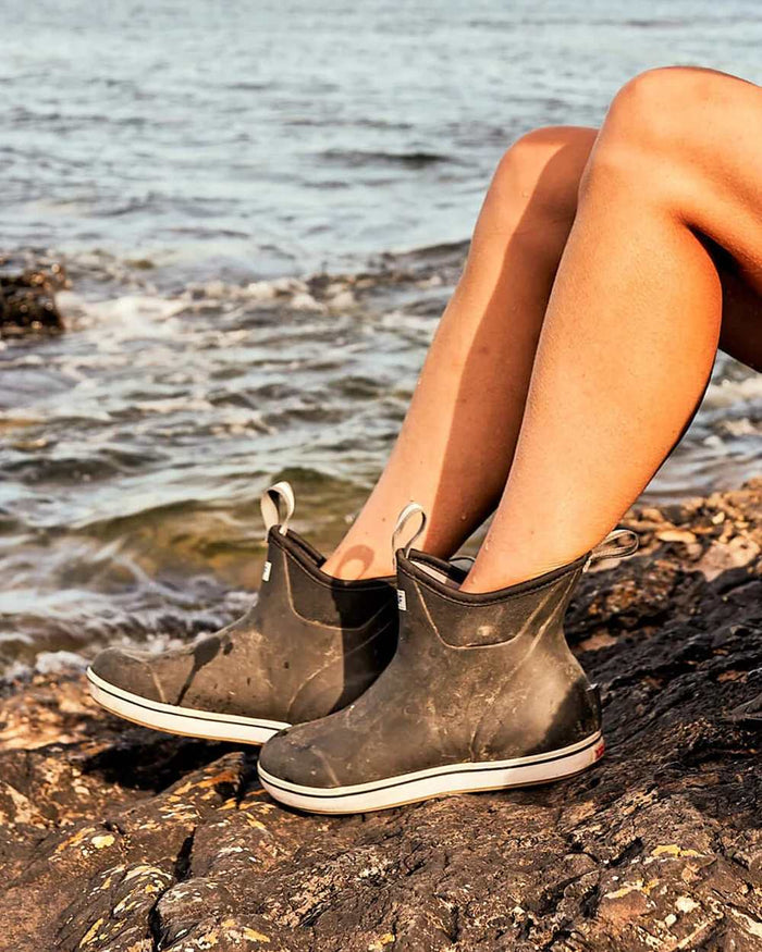 Black Coloured Xtratuf Womens 6" Ankle Deck Boots on outdoor  background #colour_black